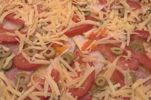 Backgroung made of white grated cheese, tomatoes,olives