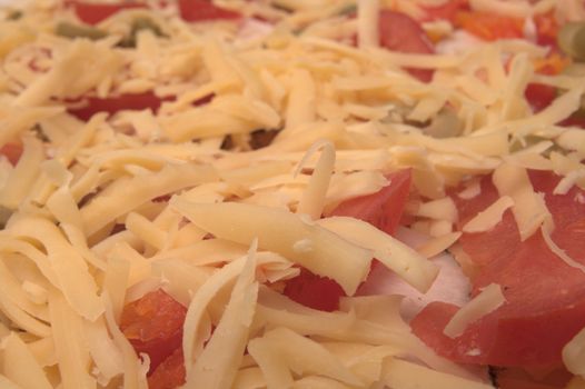 Backgroung made of white grated cheese, tomatoes,olives