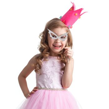 Funny princess girl in pink dress and crown holding party glasses on stick