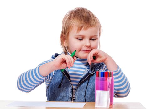 Little Girl drawing picture at table isolated on white