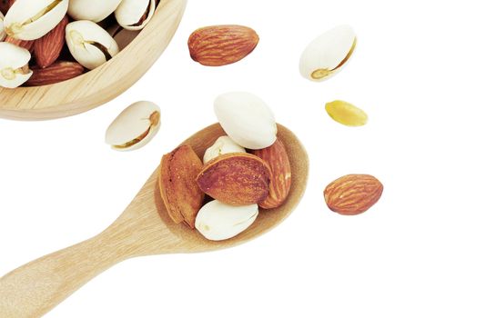 Almonds on wooden spoon and bowl with a white background.