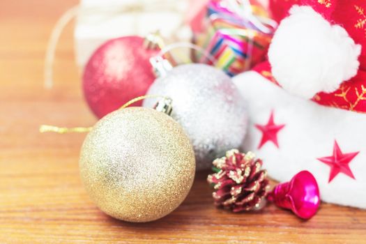 Balls with decorations and gift boxes on wooden.