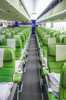 Green Airplane seats in cabin. Interior view