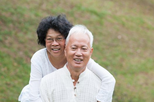 Portrait of senior Asian couple relaxing at outdoor park.