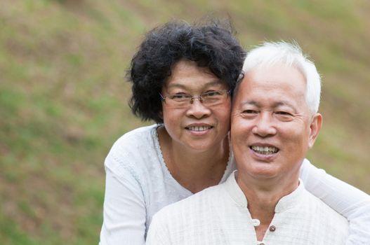 Portrait of old Asian couple relaxing at outdoor park.