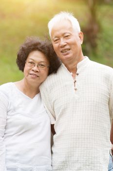 Happy elderly Asian seniors couple at outdoor park.