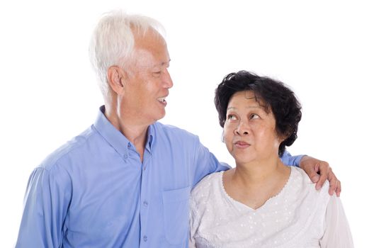 Happy Asian elderly couple smiling,  standing isolated on white background.