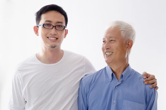 Asian old father and son smiling,  standing isolated on white background.