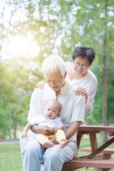Grandparents with baby grandson, Asian family with grandchild, life insurance concept.