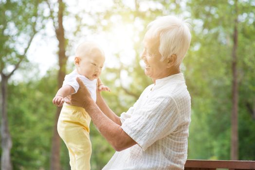 Senior old man with baby grandchild, Asian  family, life insurance concept.