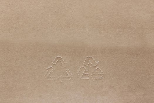 Stamp Recycling signs on recycling Natural color paper. Brown cardboard with horisontal strips