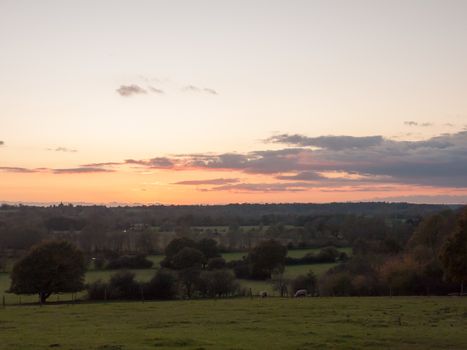 beautiful country scene fields trees horizon sky red autumn sun set Dedham Vale; essex; england; uk