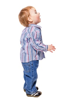 Happy child little boy standing looking up isolated on white