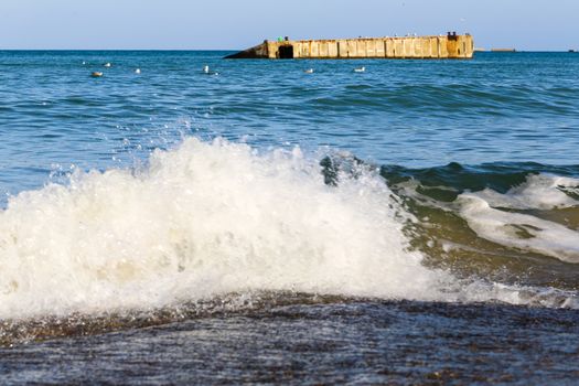 Ruins of harbor built by the Allies in Arromanches, Normandy, France