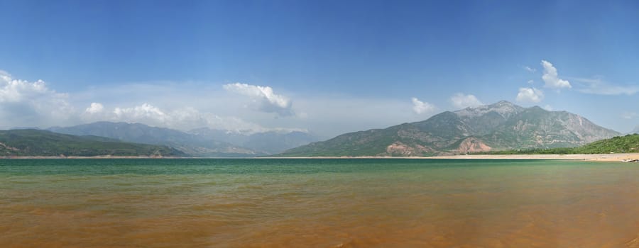 Panoramic view oj Charvak lake, resort area near Tashkent, on a sunny day