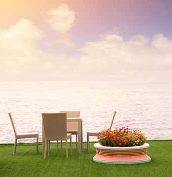 Rattan armchairs on the terrace lounge with sea view background.