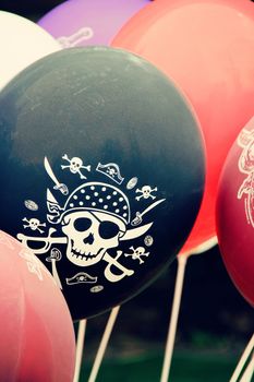 a lot of red white black purple balloons for pirate party. photo