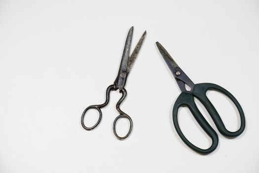 Old paper cutting scissors on a white background. Tailoring and gardening.