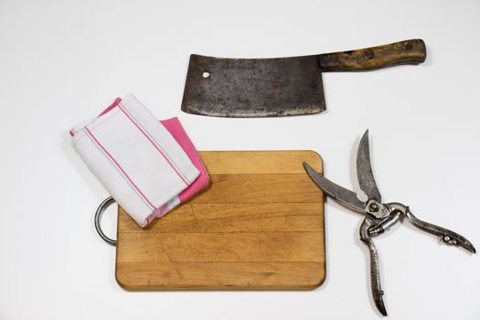 Old chopper and board, tools for butcher, white background.