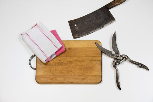 Old chopper and board, tools for butcher, white background.