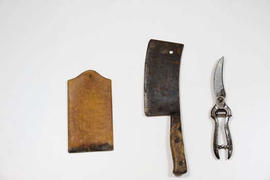 Old chopper and board, tools for butcher, white background.