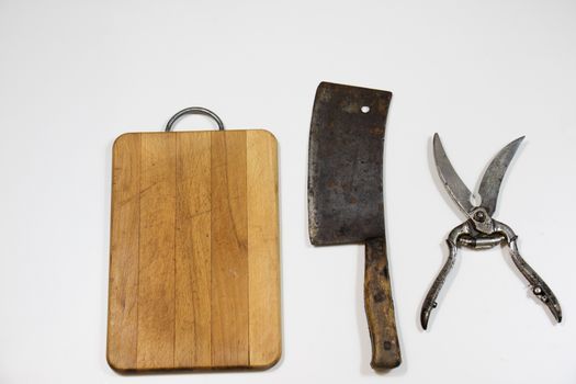 Old chopper and board, tools for butcher, white background.