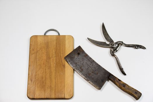 Old chopper and board, tools for butcher, white background.