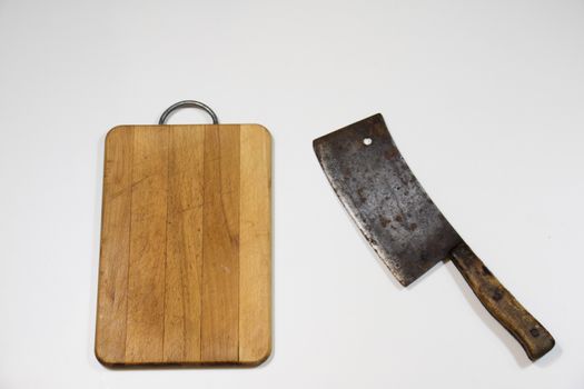 Old chopper and board, tools for butcher, white background.