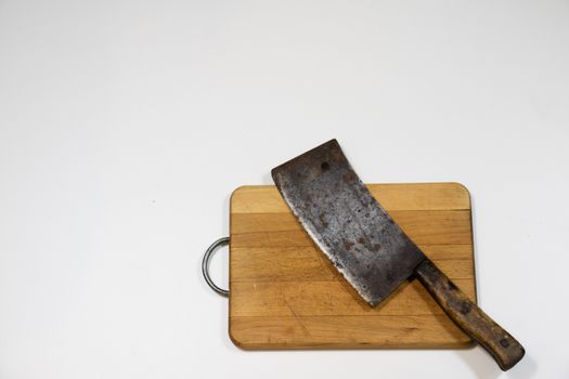 Old chopper and board, tools for butcher, white background.