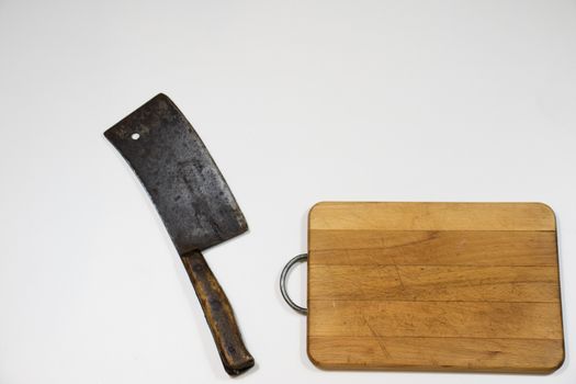 Old chopper and board, tools for butcher, white background.