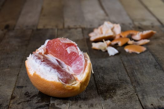 Picked grapefruit on a wooden table, juices and peaches, old kitchen