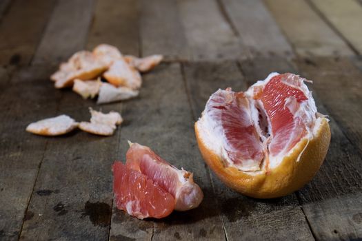 Picked grapefruit on a wooden table, juices and peaches, old kitchen