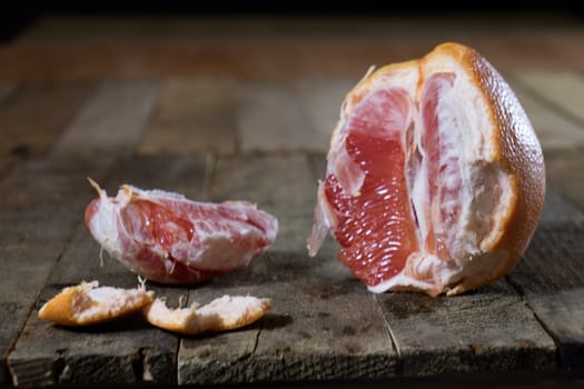 Picked grapefruit on a wooden table, juices and peaches, old kitchen