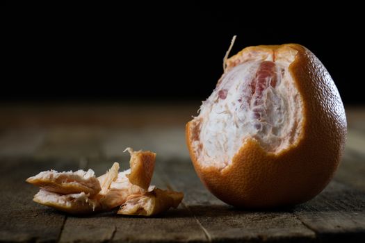 Picked grapefruit on a wooden table, juices and peaches, old kitchen