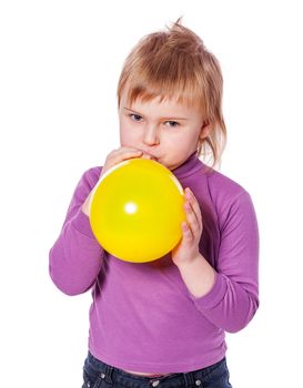 Little girl inflating yellow balloon isolated over white