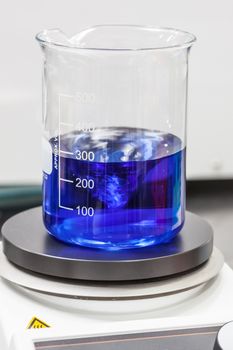 Glass beaker on top of a magnetic laboratory stirrer