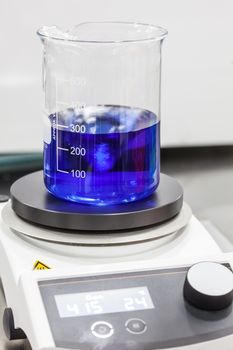 Glass beaker on top of a magnetic laboratory stirrer
