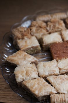 Tasty and sweet Turkish cookies on a transparent plate in room. Food concept.