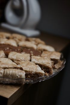 Tasty and sweet Turkish cookies on a transparent plate in room. Food concept.