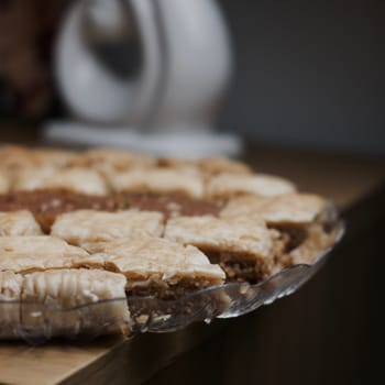 Tasty and sweet Turkish cookies on a transparent plate in room. Food concept.