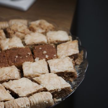 Tasty and sweet Turkish cookies on a transparent plate in room. Food concept.