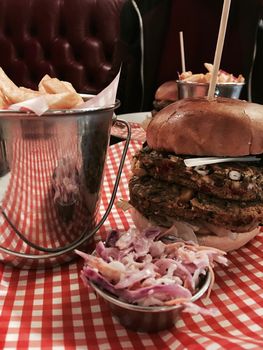 Big, fresh and delicious vegetable burger in restaurant on the white plate.