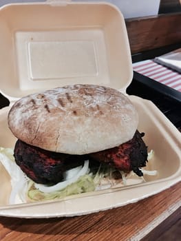 Delicious and fresh red meat chicken burger in a box. Fast food concept.