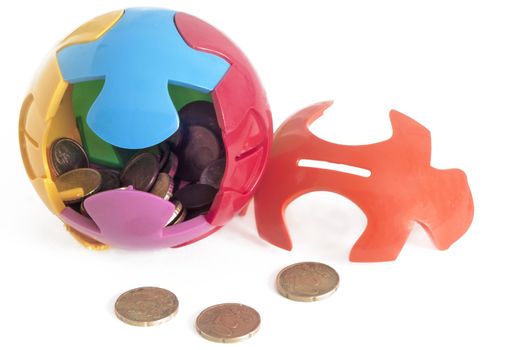 puzzle-shaped piggy bank and some coins