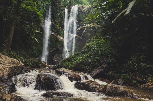 Beautiful waterfall in green forest in jungle .