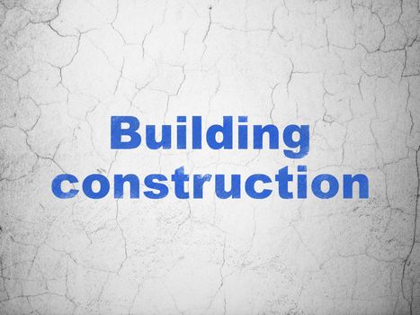 Constructing concept: Blue Building Construction on textured concrete wall background