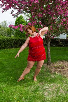 forty something woman dancer wearing a sparkly dress in position