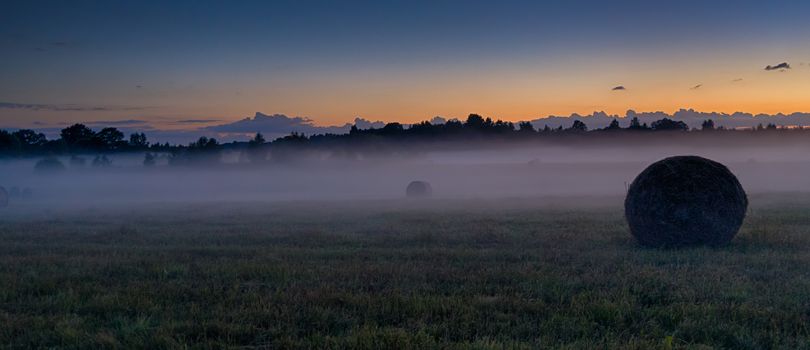 Latvia vidzeme landscape at sunset with fog and mist