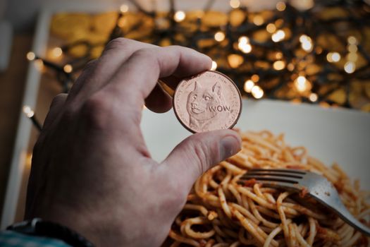 Digital currency physical brass dogecoin coin. Italian pasta food concept.