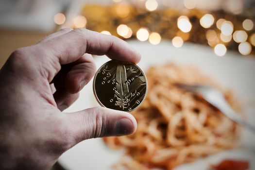 Digital currency physical gold feather coin. Italian pasta food concept.